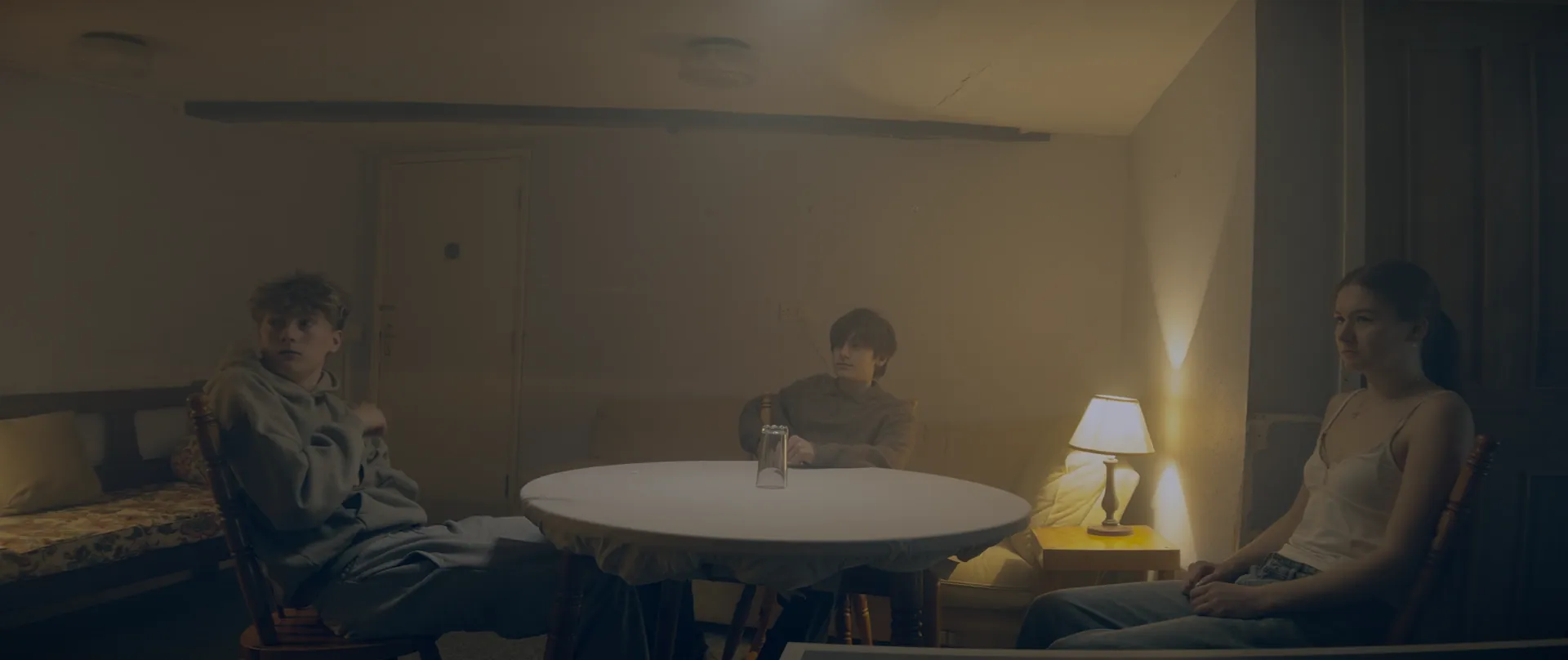 Wide shot of the three participants around the table