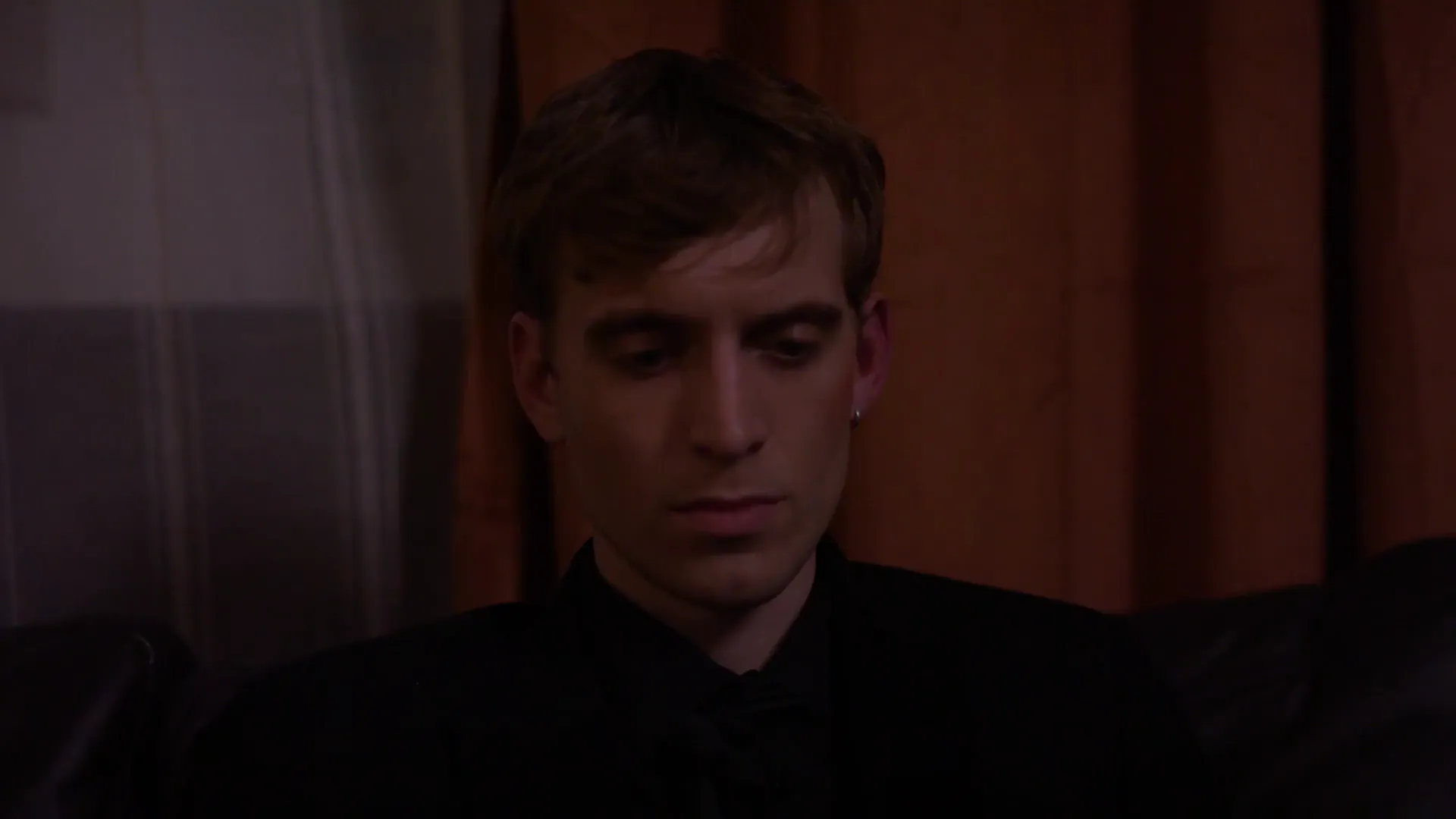 Close-up of a young man in a dark suit