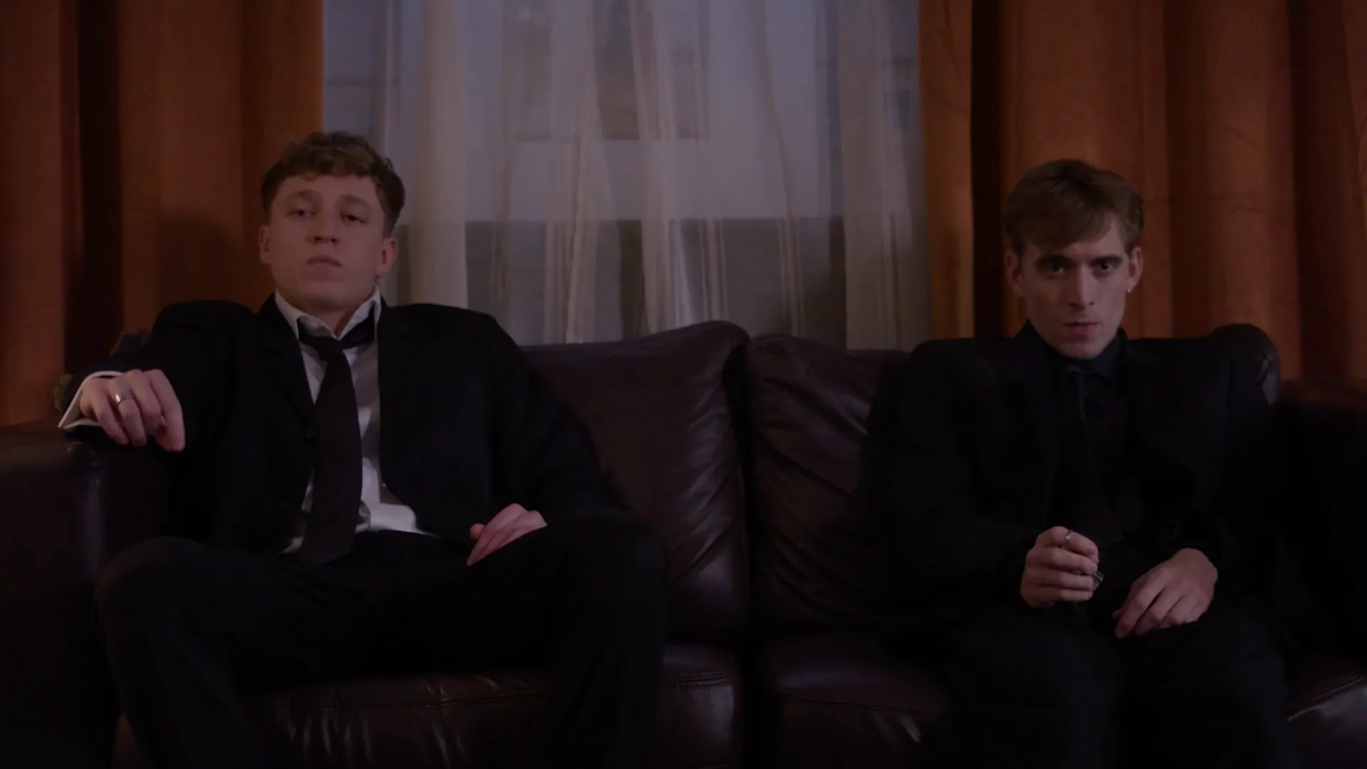 Two men on a leather sofa