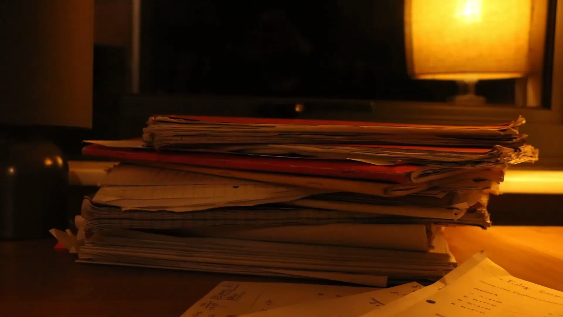 Stack of homework under the lamp